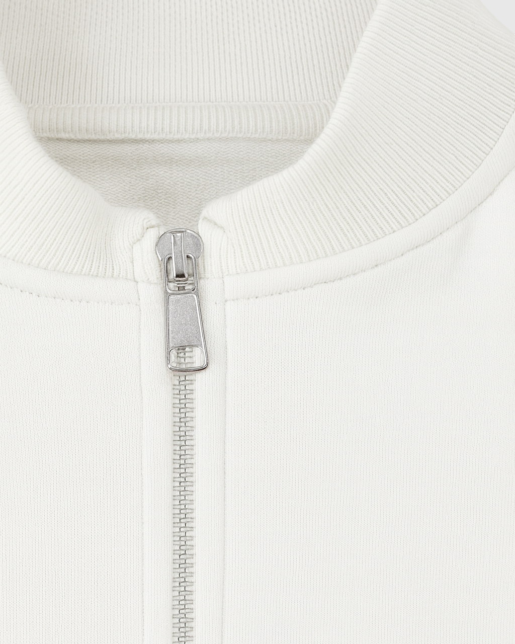 White Serena lounge set by Lumina Wear featuring casual chic style with modern zipper details, perfect for comfortable loungewear.