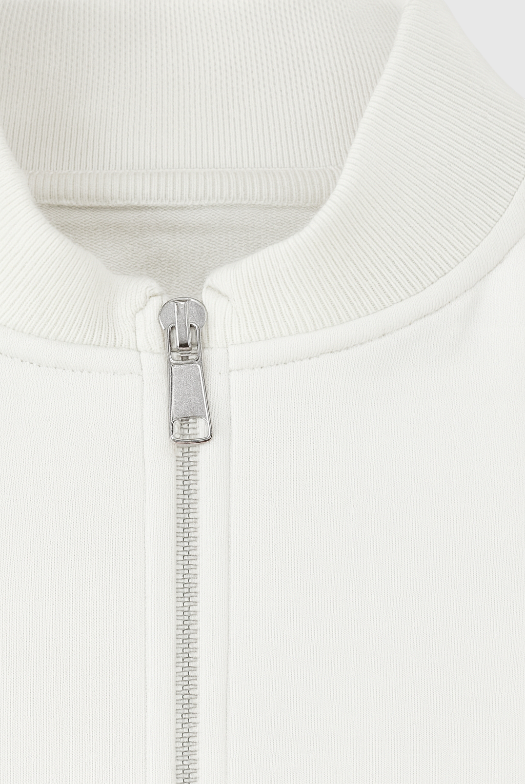 White Serena lounge set by Lumina Wear featuring casual chic style with modern zipper details, perfect for comfortable loungewear.