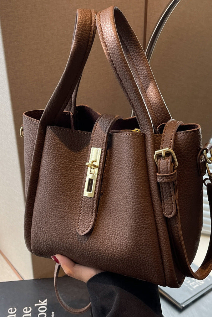 Coffee brown Serena Lumina retro crossbody handbag with versatile design, showing the stylish, structured purse with adjustable strap.