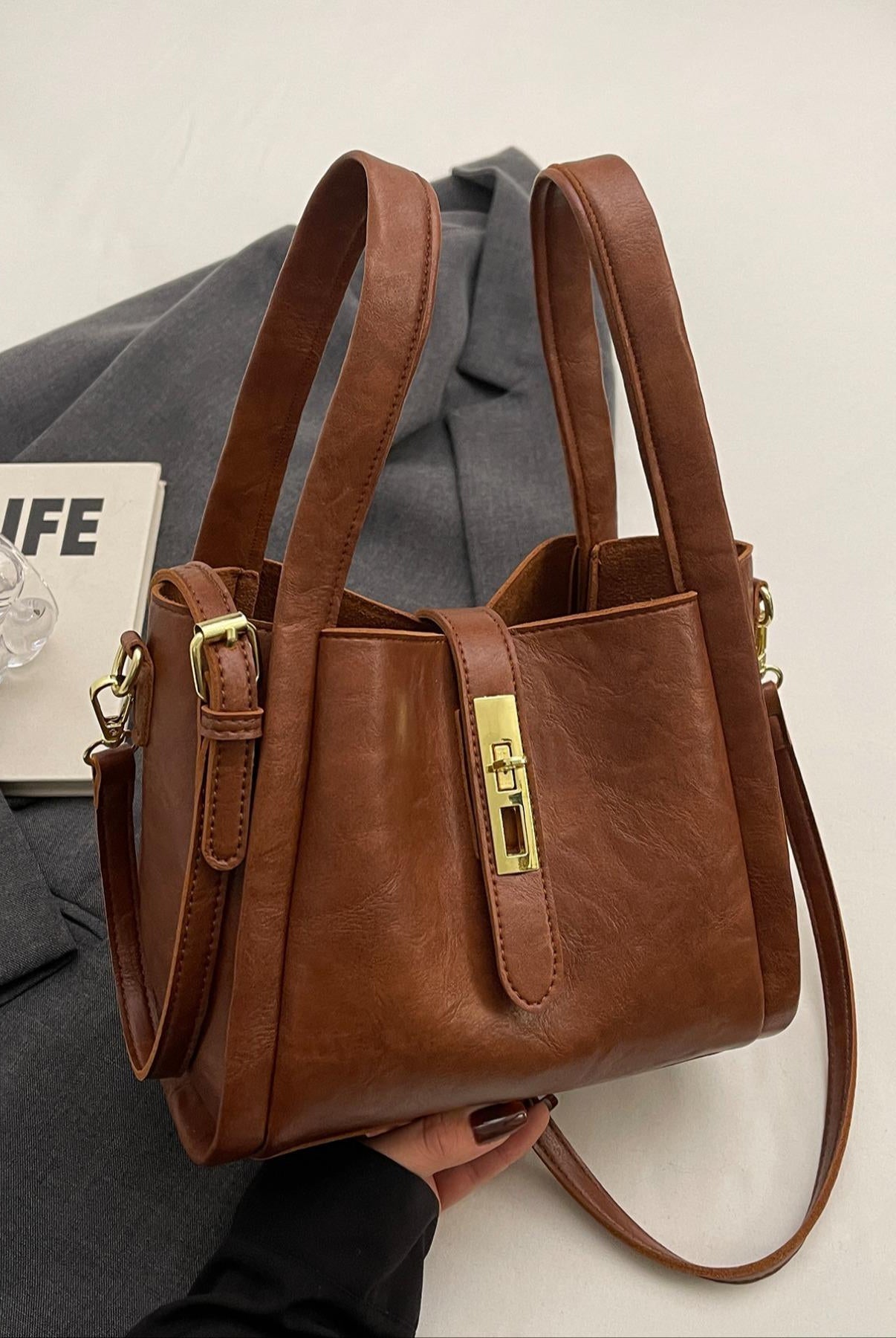 Coffee brown Lumina Wear Serena chic retro crossbody handbag with versatile design, shown with adjustable strap and stylish exterior.