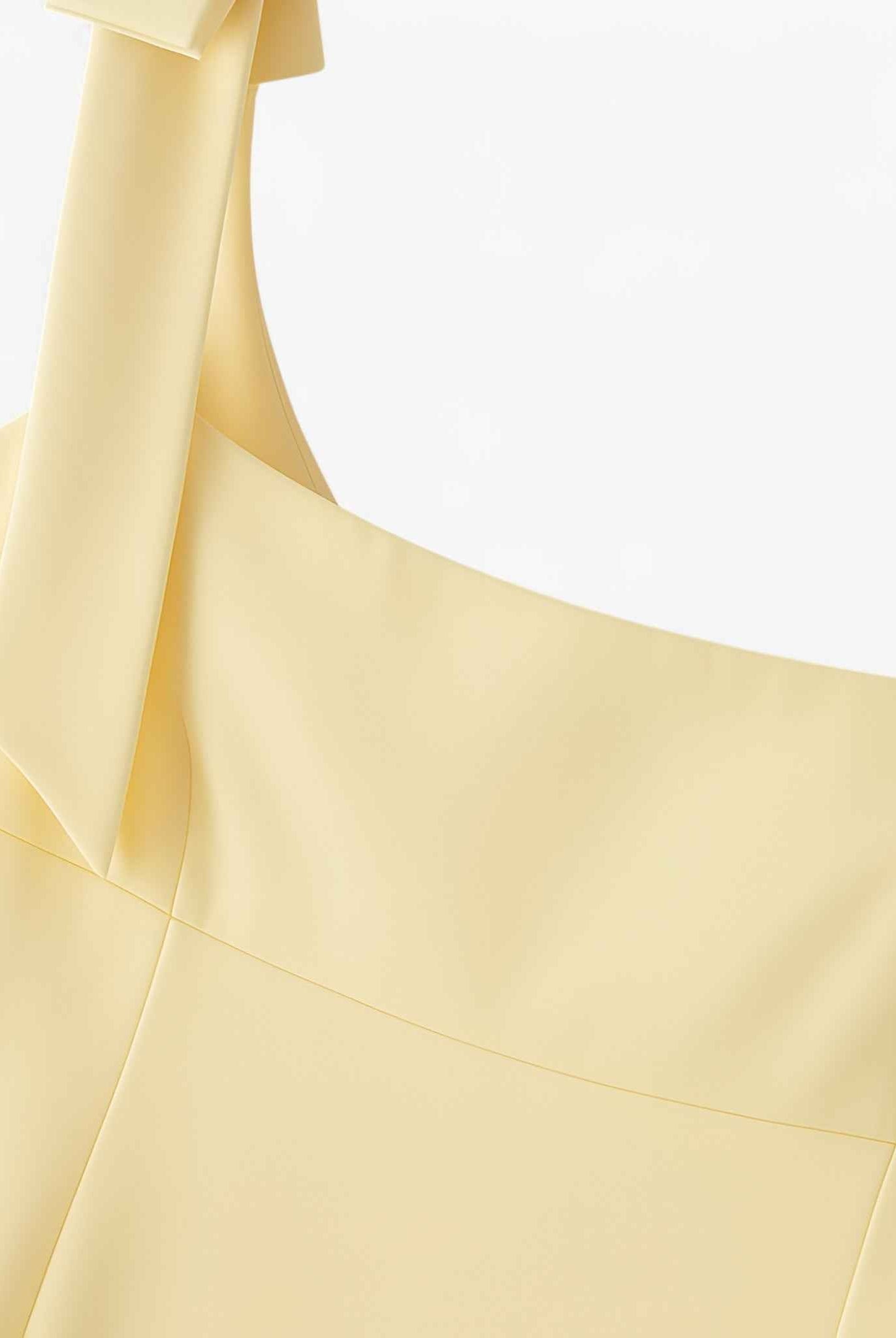 Yellow slim fit camisole tank top with bow detail by Lumina Wear, featuring a playful and stylish design.