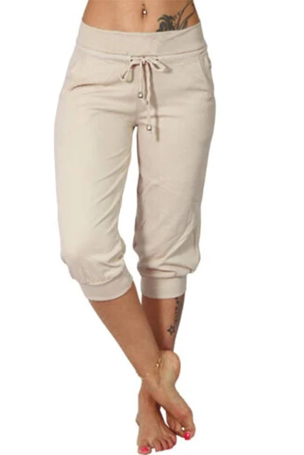 Trendy grey Capri trousers with elastic waistband by Lumina Wear, shown on a model with a beige background.