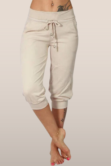 Trendy grey Capri trousers with elastic waistband from Lumina Wear, casual fit, comfortable stretch fabric, styled on a model.