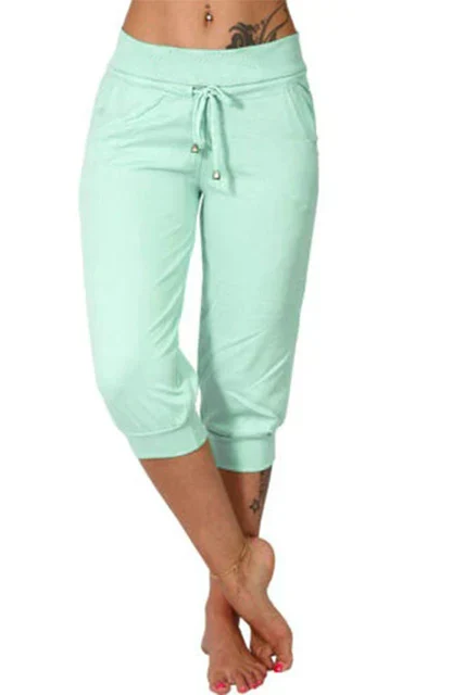 Trendy grey Capri trousers by Lumina Wear with elastic waistband, shown on a model, casual stylish summer pants.