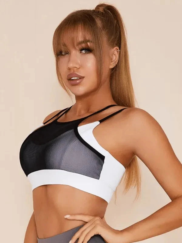 White Lumina Vancouver mesh sports bra with sexy back design, featuring breathable fabric and supportive fit.