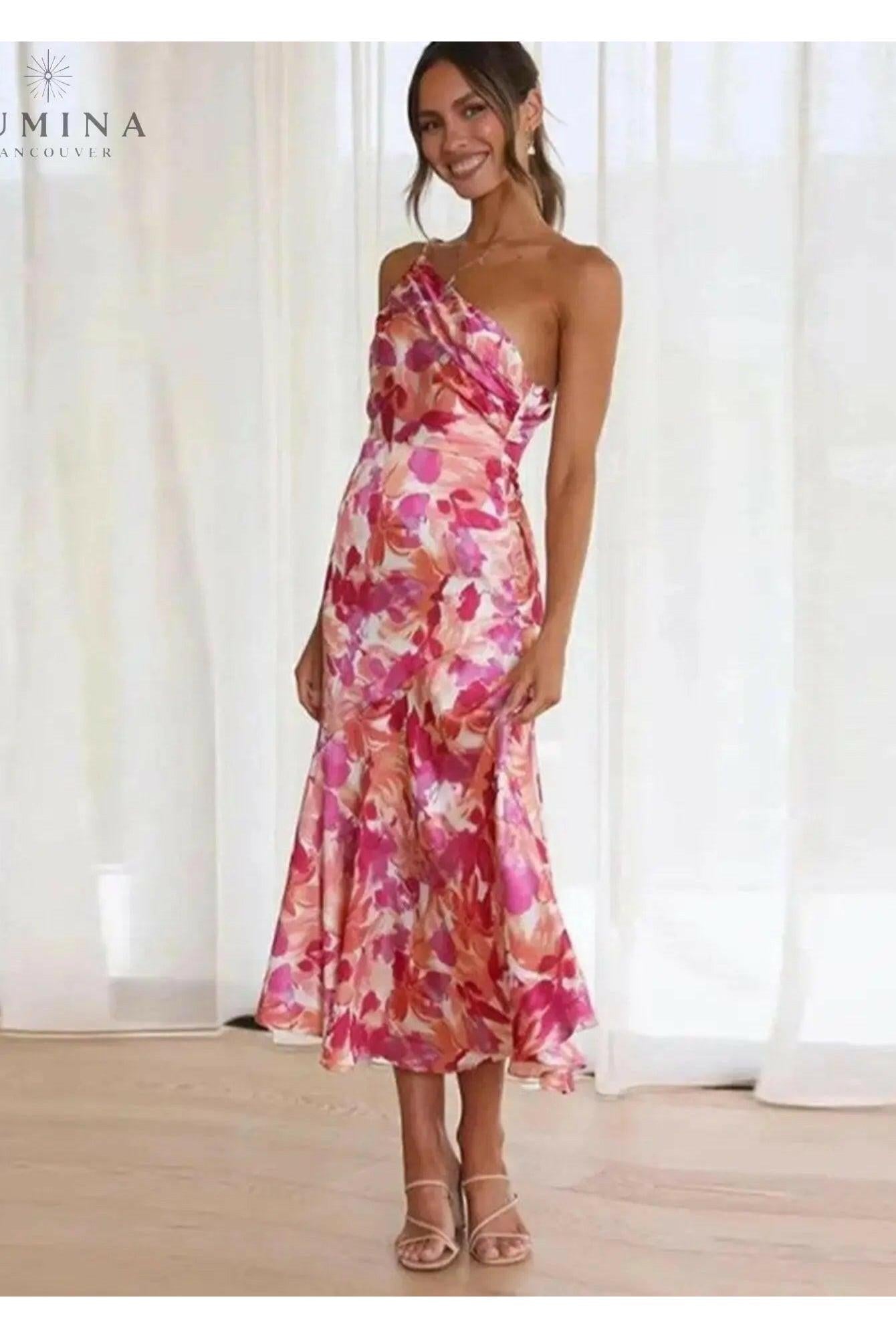 Tiphaine floral pattern dress by Lumina Wear, orange S-sized dress with vibrant floral design, displayed on a hanger.