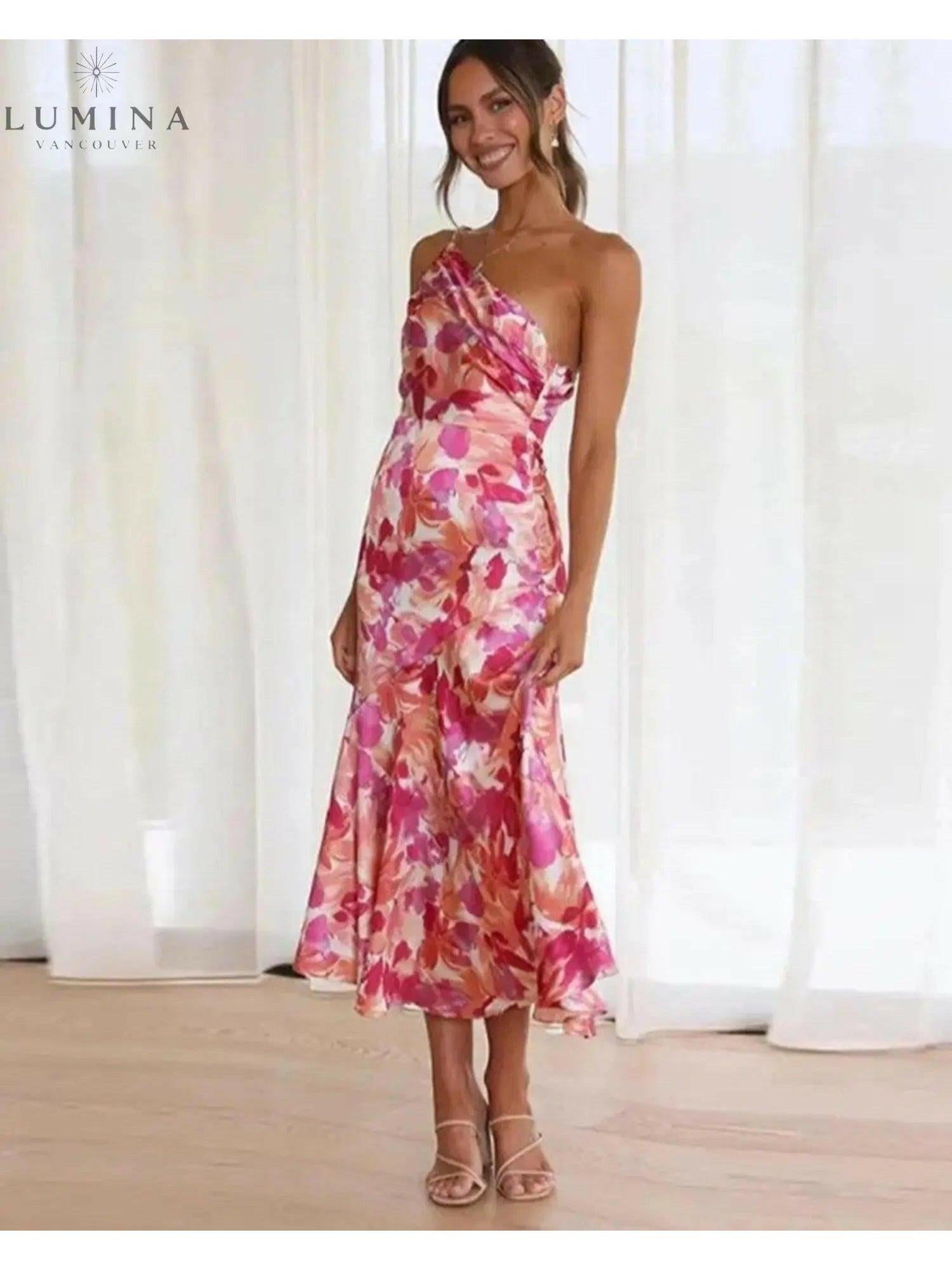 Orange floral patterned Tiphaine dress by Lumina Vancouver, showcasing a stylish and vibrant women's dress with floral details.