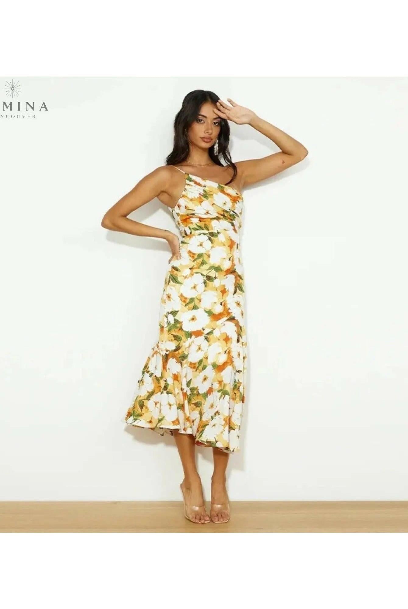Tiphaine floral pattern dress by Lumina Wear, orange S-sized dress with vibrant floral design, displayed on a hanger.