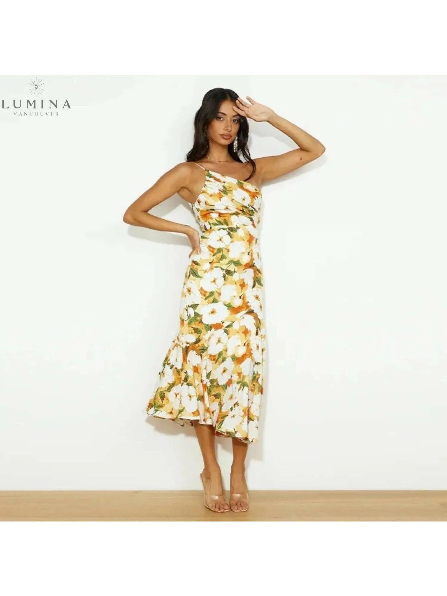 Tiphaine floral patterned dress by Lumina Vancouver in vibrant orange with a stylish, flowing design and elegant floral details.