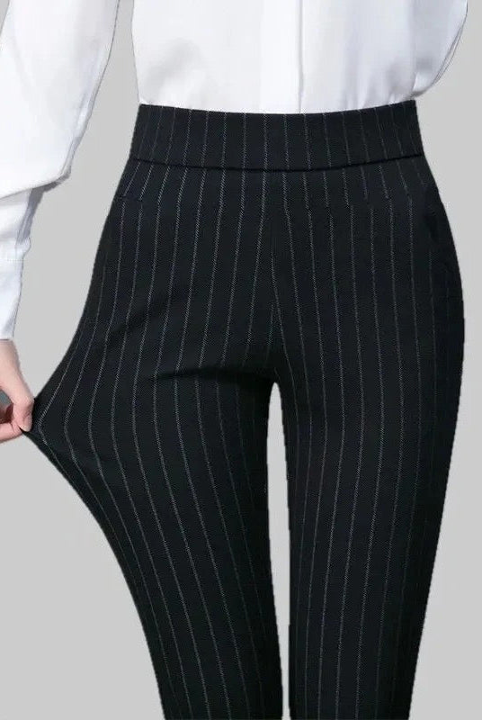 Elegant fitted black Lumina Wear trousers with stretch fabric, featuring subtle stripe details and a tailored silhouette.