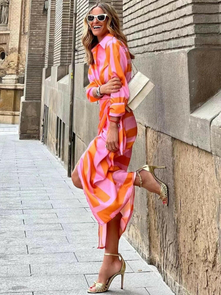 Orange and pink Solana™ printed wrap dress by Lumina Vancouver, featuring a stylish design and flowing fabric.