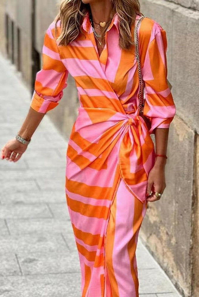 Orange and pink printed wrap dress from Lumina Wear's Solana collection, featuring a stylish, flowing design.