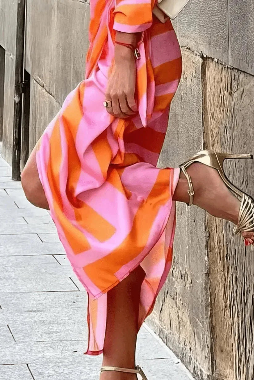 Lumina Wear Solana printed wrap dress in orange and pink, stylish short dress with a vibrant floral pattern.