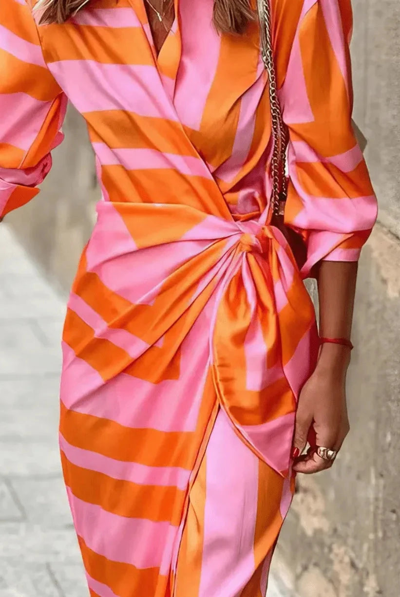 Lumina Wear Solana printed wrap dress in orange and pink, flowing lightweight dress with floral pattern, perfect for summer wear.