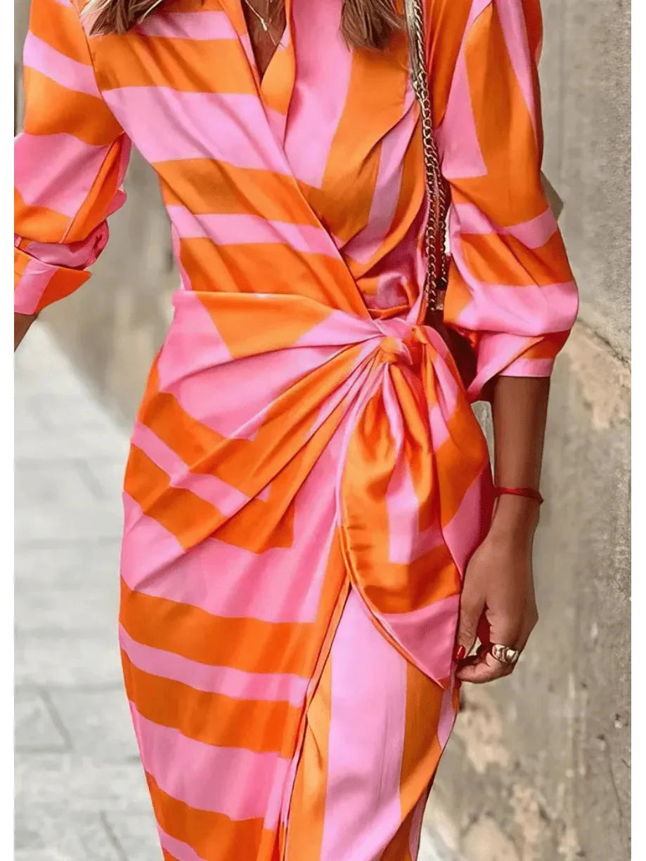 Orange and pink printed Solana™ wrap dress by Lumina Vancouver, featuring a stylish design perfect for warm weather.