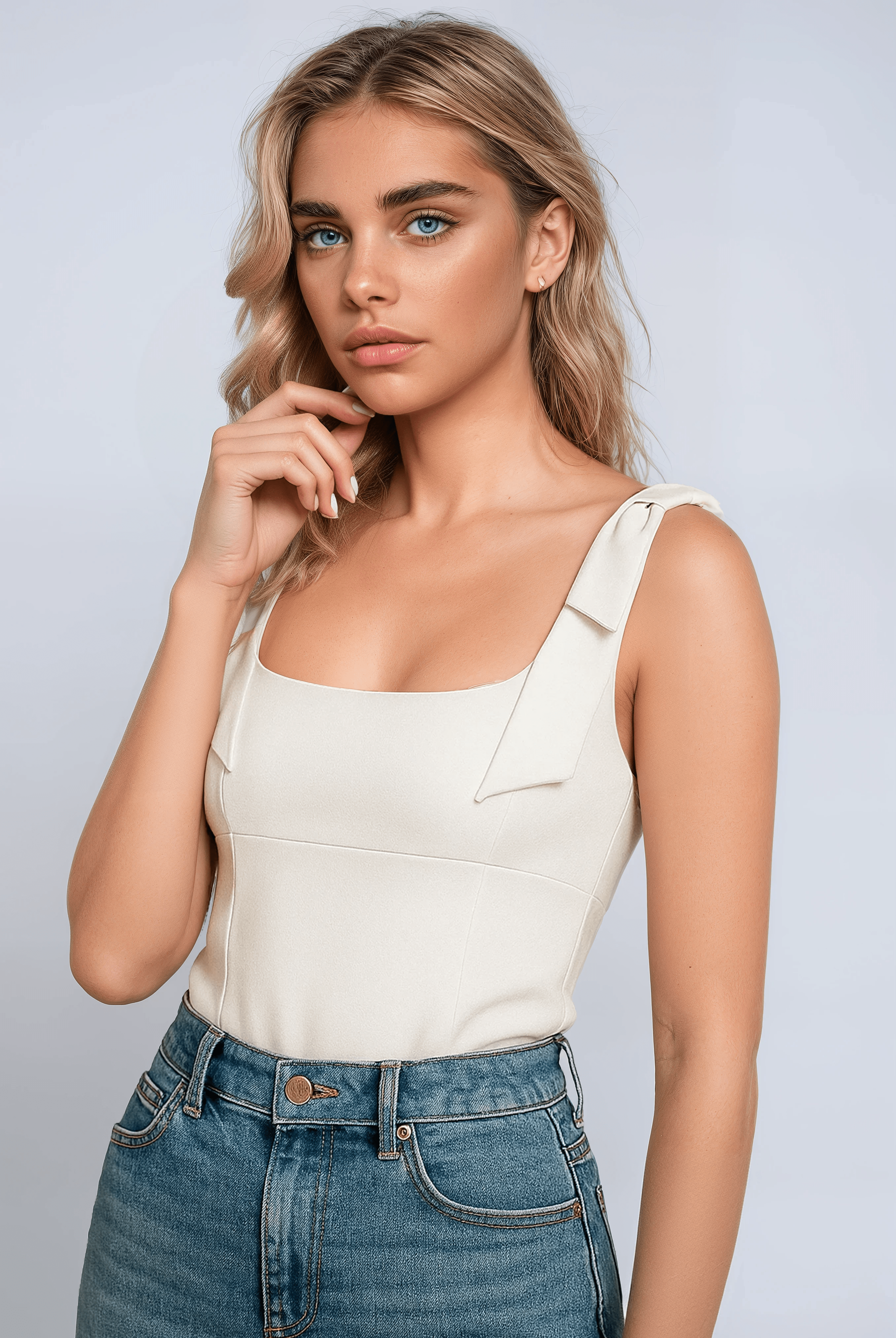 White Sophia bow-detail cami top with zipper closure by Lumina Wear, sleeveless women's top with elegant bow accents.