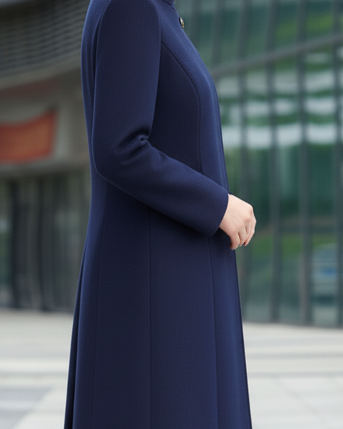 Navy blue Sophia Button Maxi Coat by Lumina Wear, styled on a model, showcasing its length and classic coat design.