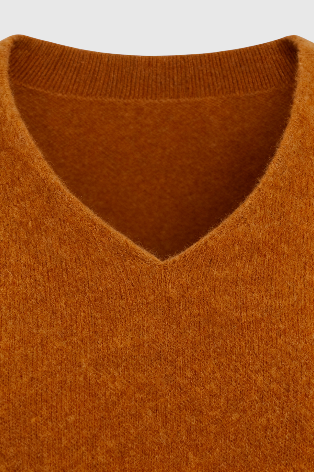 Lumina Wear Sophia cozy orange v-neck sweater with a flattering fit, displayed on a mannequin.