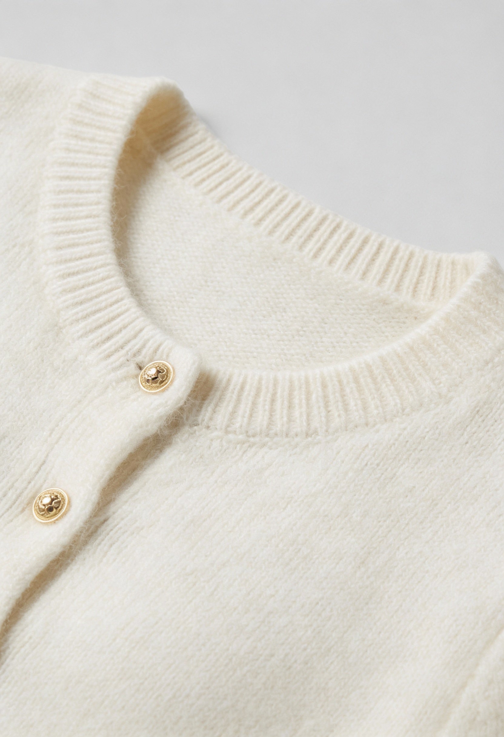 Sophia Lumina white cardigan sweater with ruffle details, cozy knit, long sleeves, and stylish design for casual wear.