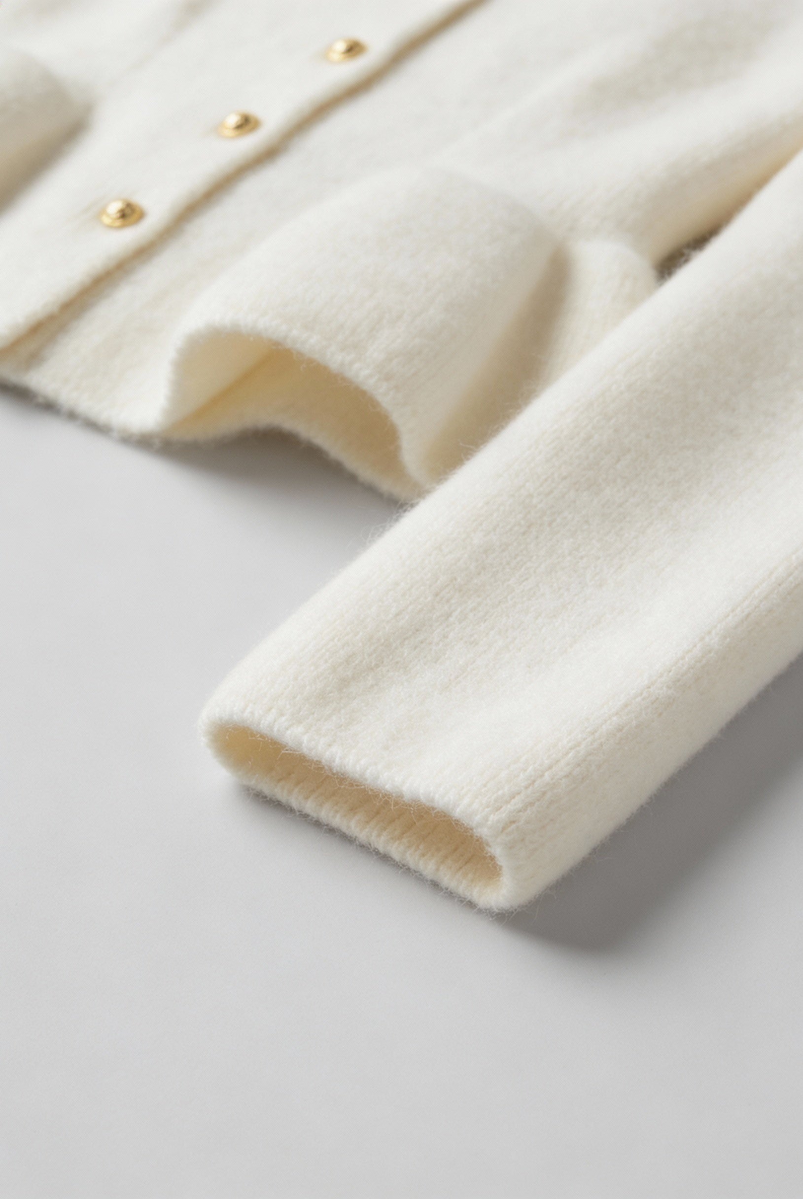 Lumina Wear Sophia cozy white cardigan sweater with ruffle details, soft knit, long sleeves, and stylish design.