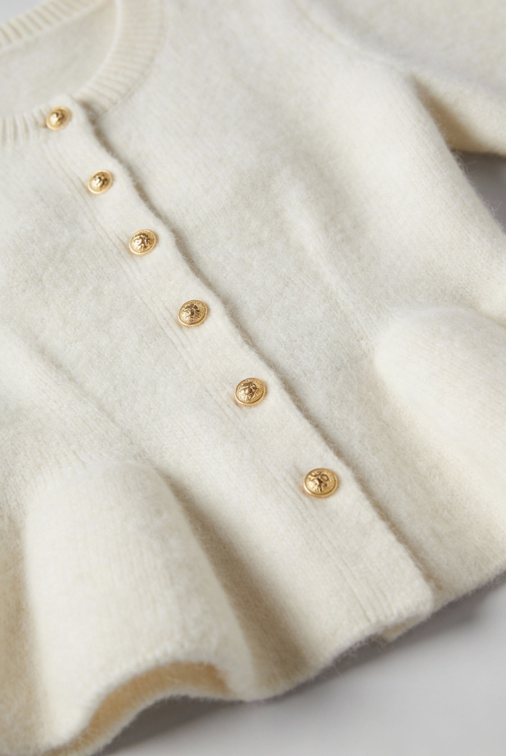 Sophia Lumina white cardigan sweater with ruffle details, cozy knit, long sleeves, perfect for casual wear.