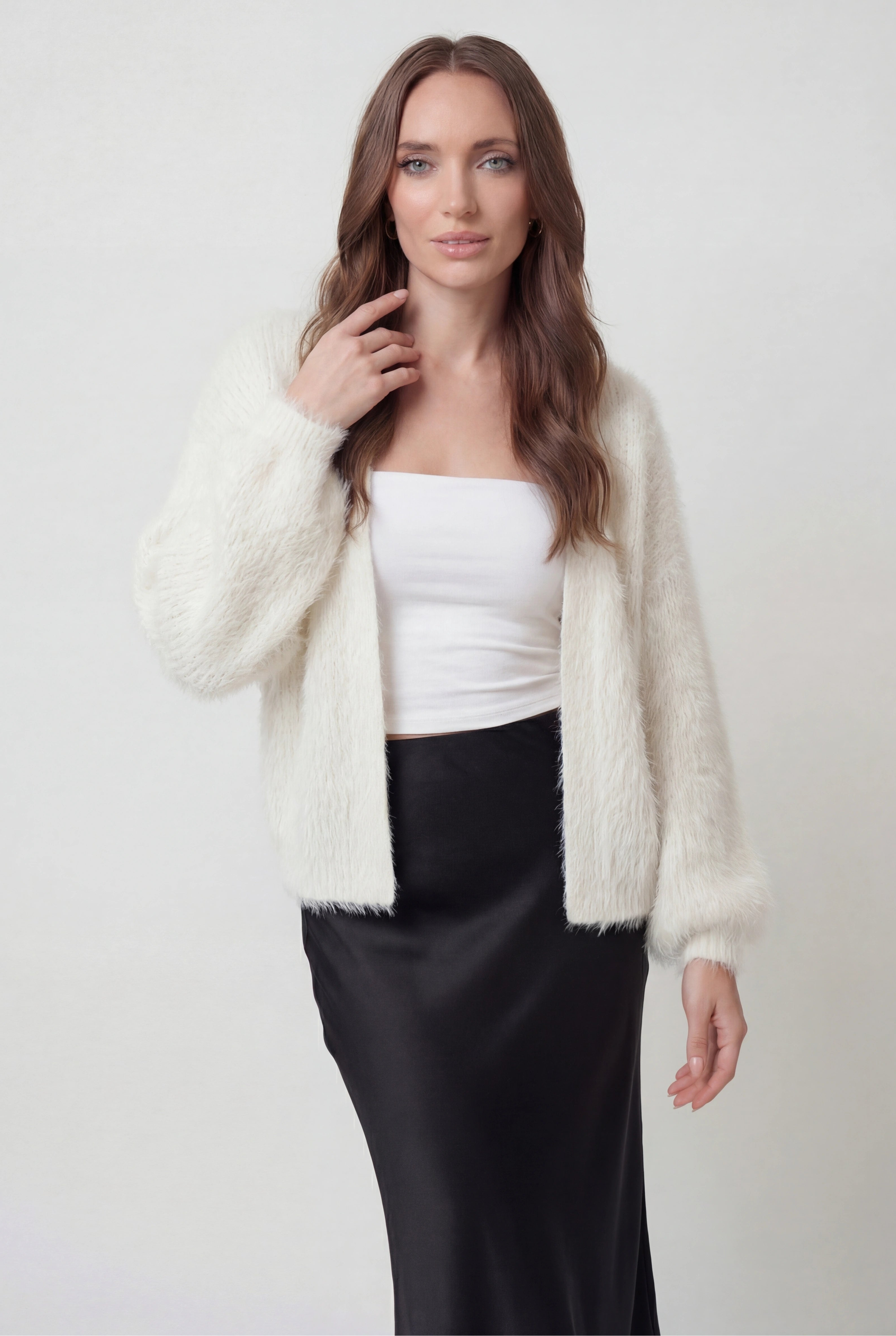 White knit cardigan named Sophia by Lumina Wear featuring a cozy fit and ribbed hem, perfect for layered winter style.