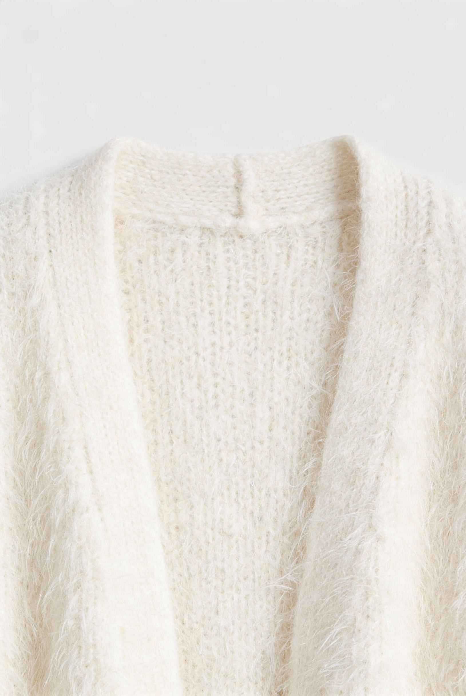 Lumina Wear Sophia cozy white knit cardigan with ribbed hem, featuring a soft, warm sweater style perfect for casual wear.