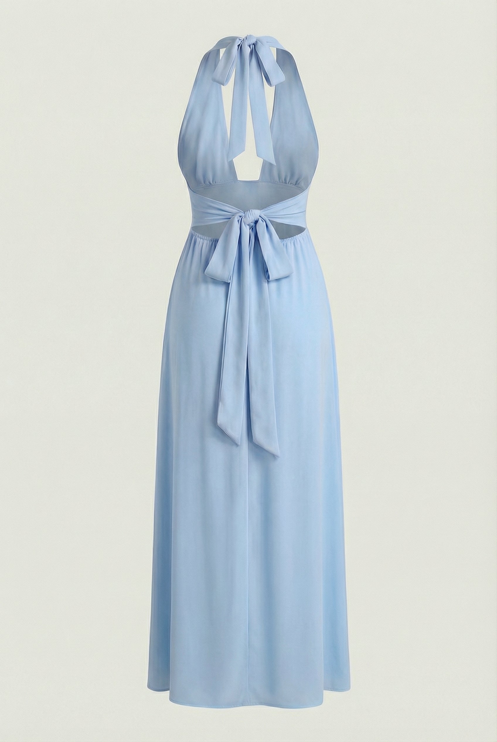 Elegant blue Maxi Dress by Lumina Wear, featuring a backless design and flowing silhouette, showcased on a model.