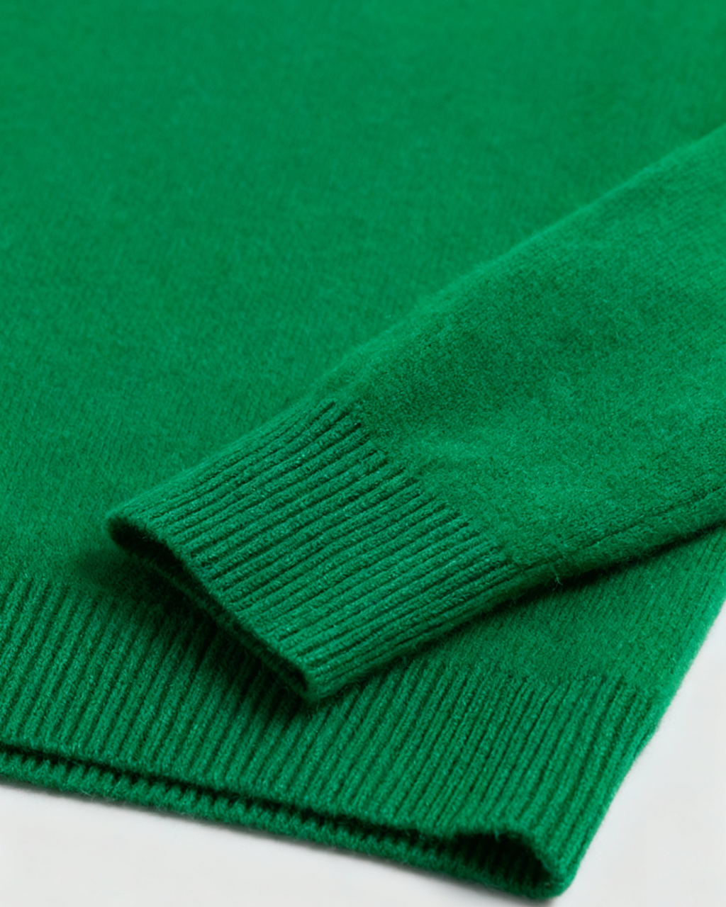 Elegant green Lumina Wear Sophia V-neck sweater with fitted silhouette, displayed on a hanger against a plain background.