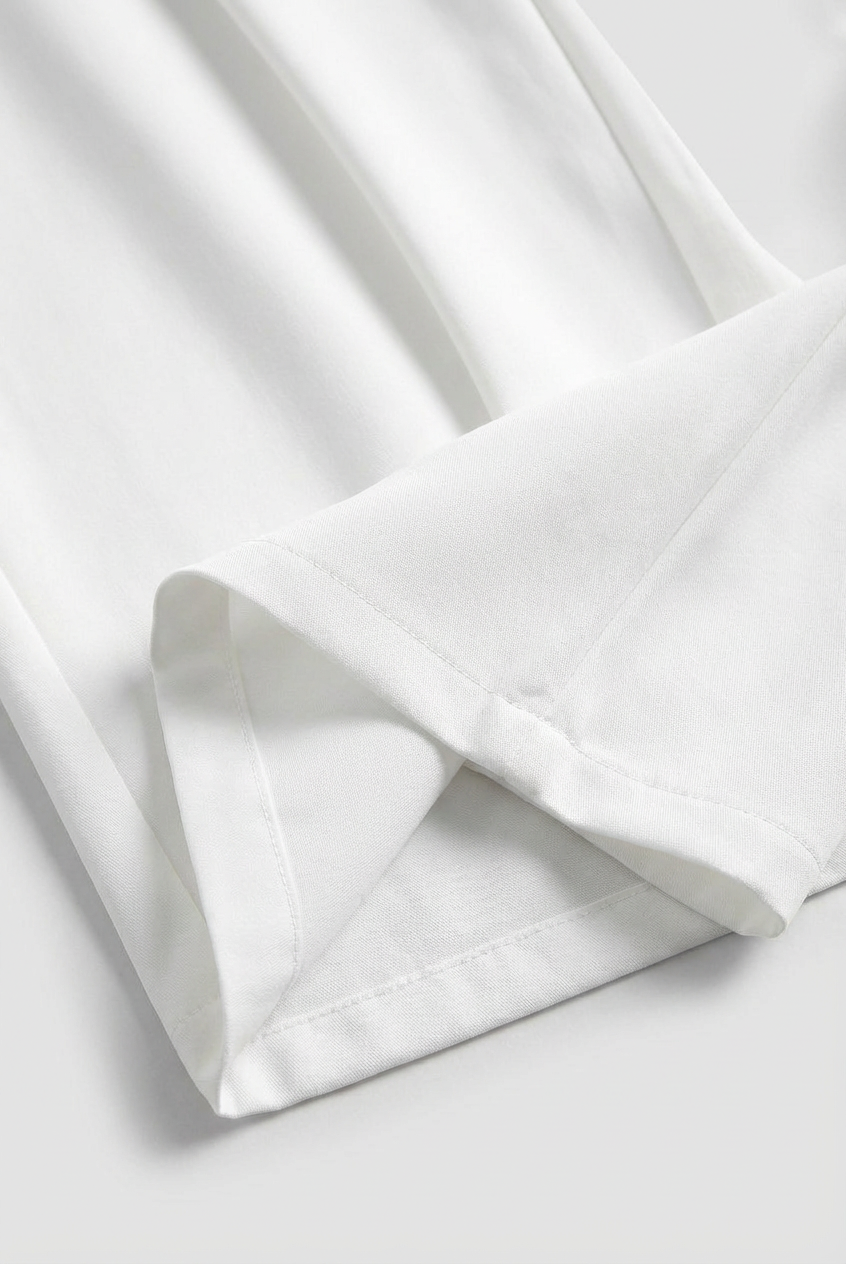 White Sophia high-waisted pleated trousers with stretch from Lumina Wear, showcasing tailored fit and elegant design.