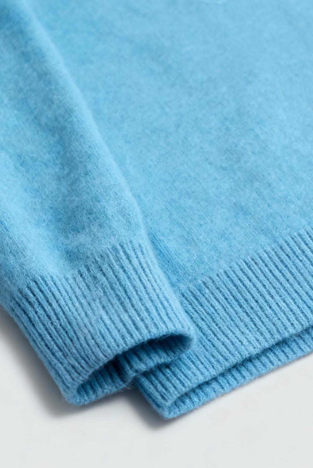 Light blue V-neck women's sweater by Lumina Wear, fitted silhouette, showcasing a cozy, stylish sweater for women.