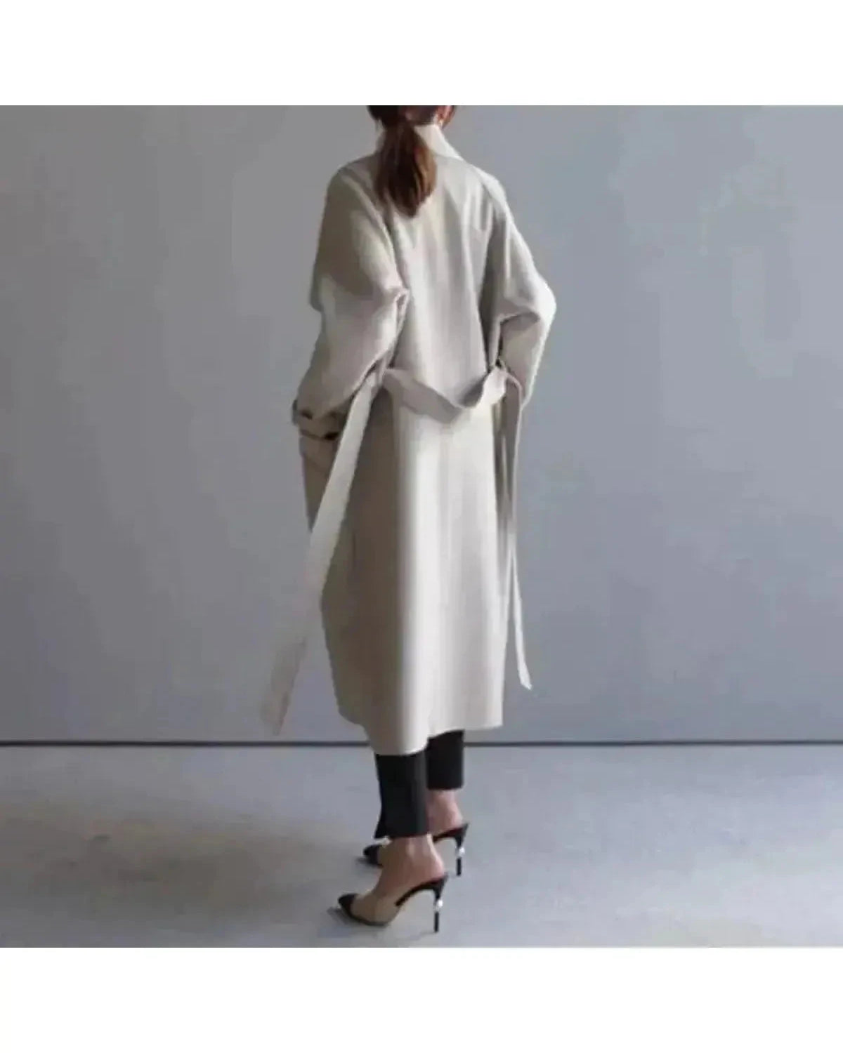 Beige Sophie elegant long coat for women by Lumina Wear, showcasing a stylish, tailored design with a collar and button details.