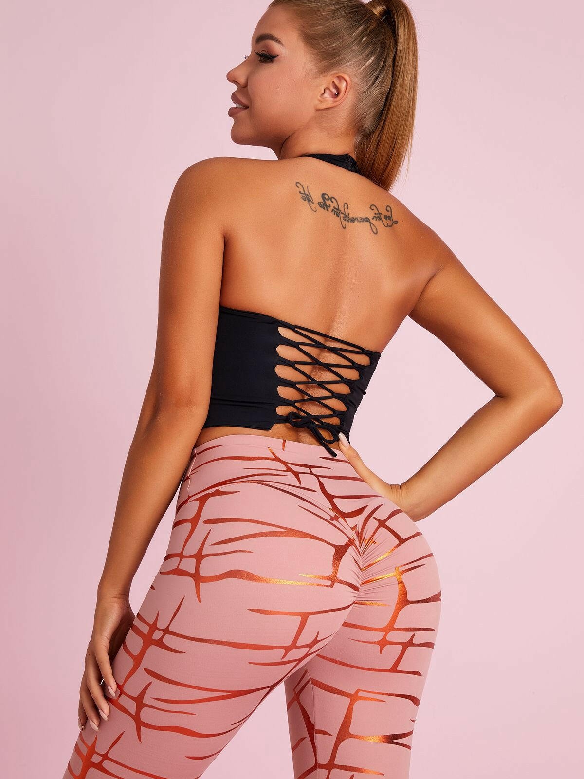 Black Lumina Vancouver sports bra with Roman knot halter design and beautify back detail, ideal for active wear and workout support.