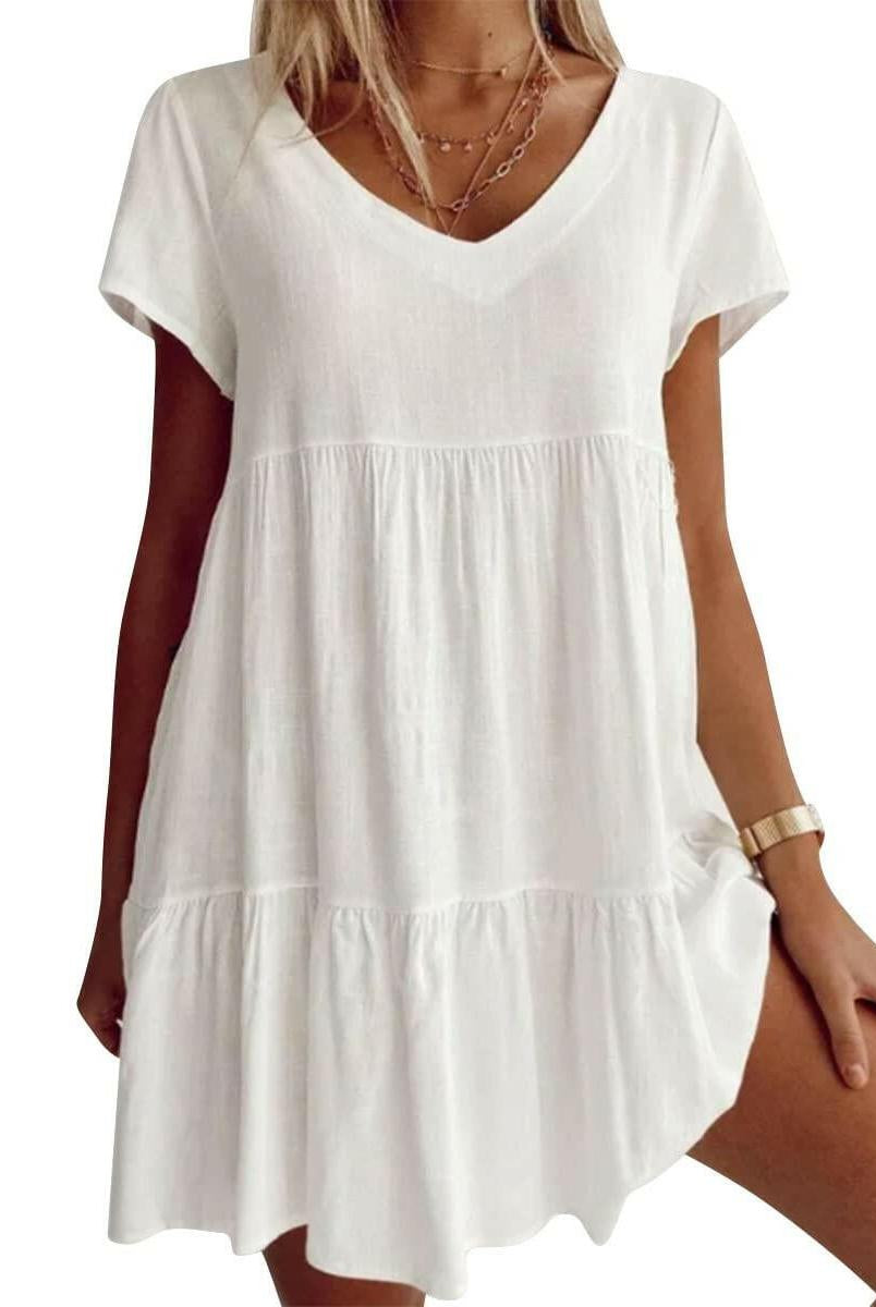 White Suzy Breezy V-Neck Dress by Lumina Vancouver, lightweight and stylish, displayed on a hanger against a neutral background.