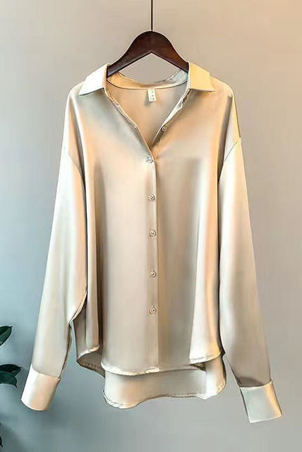 Beige Taylor Lumina relaxed fit blouse with button detail, displayed on a hanger showing its elegant, casual style.