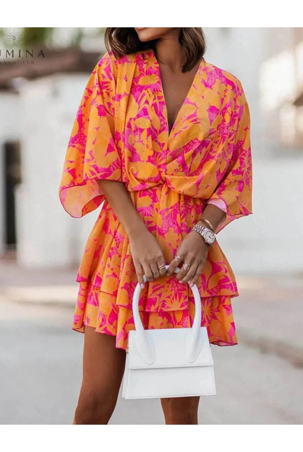 Valeria bohemian floral mini dress in orange and pink from Lumina Vancouver's summer dress collection, featuring a flowy, casual style.