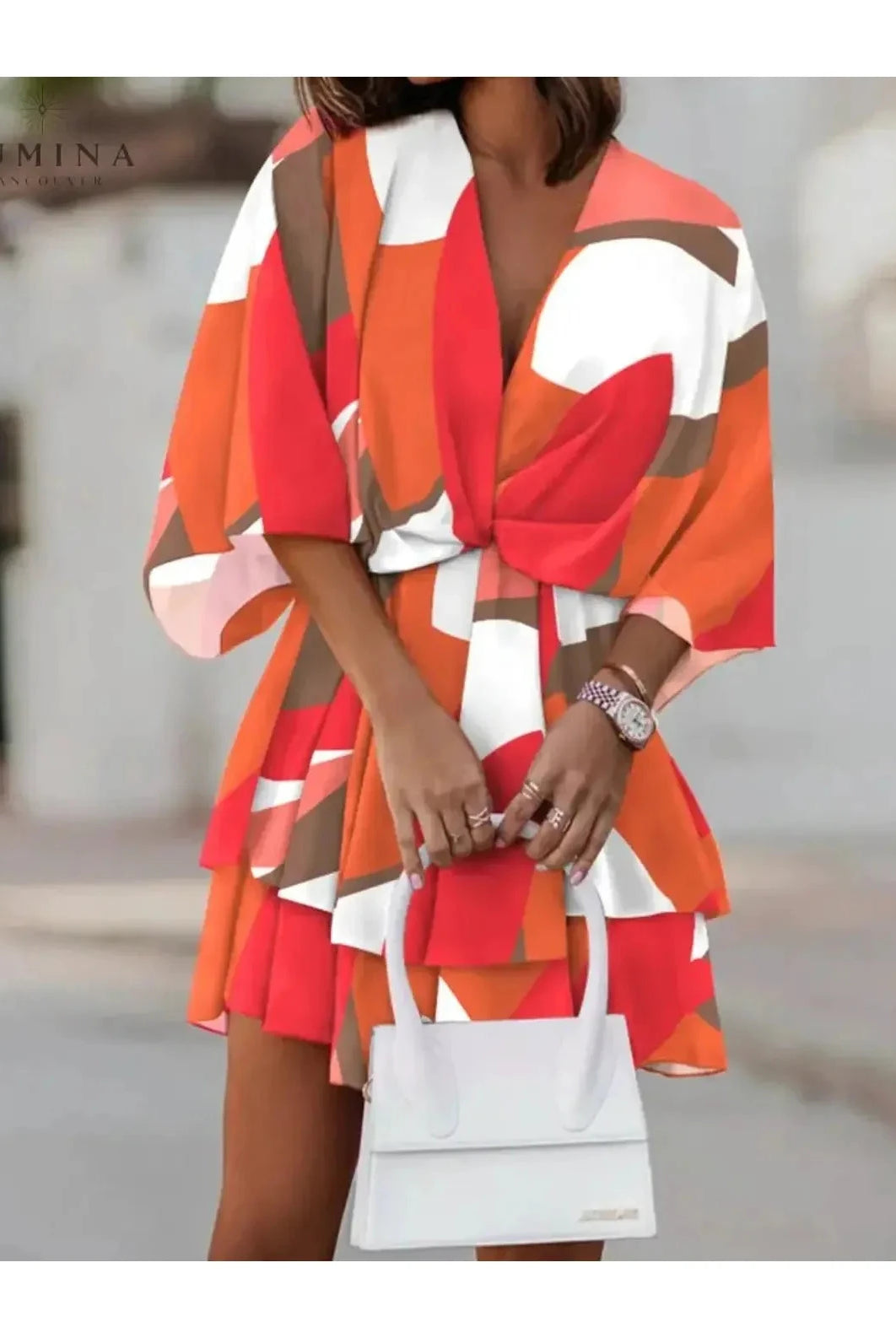 Valeria bohemian floral mini summer dress in orange and pink by Lumina Vancouver, featuring a flowy design and lightweight fabric.