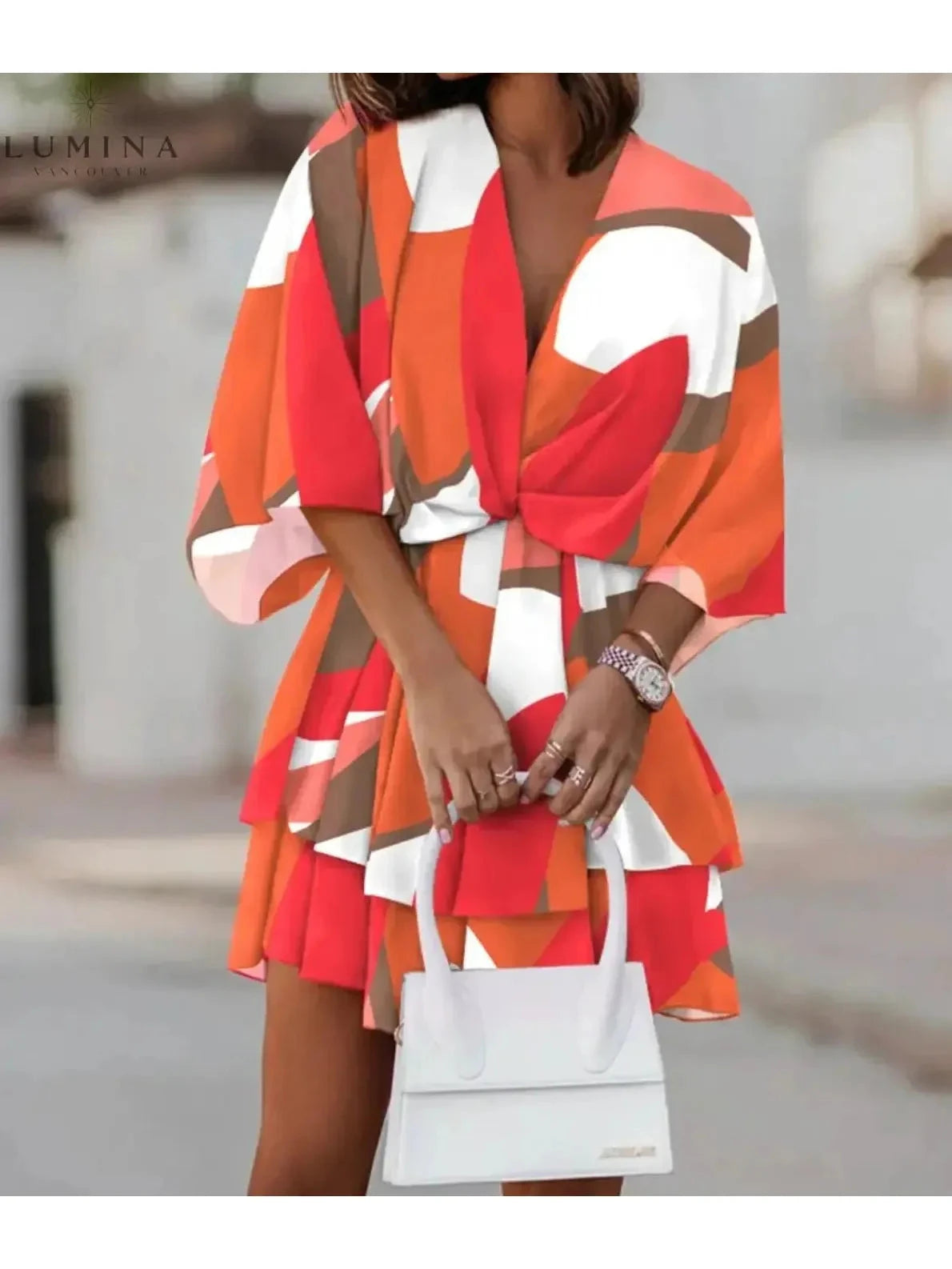 Valeria bohemian floral mini summer dress in orange and pink by Lumina Vancouver, featuring a flowy design and lightweight fabric.