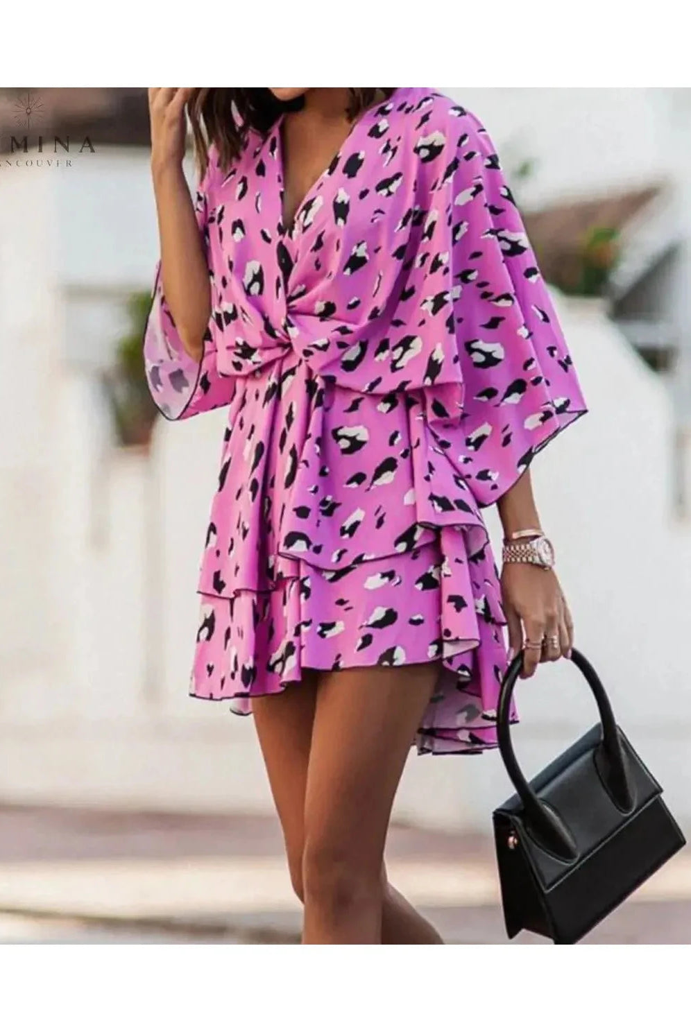 Orange and pink bohemian floral mini dress from Lumina Vancouver's summer dress collection, featuring a flowy, casual style.
