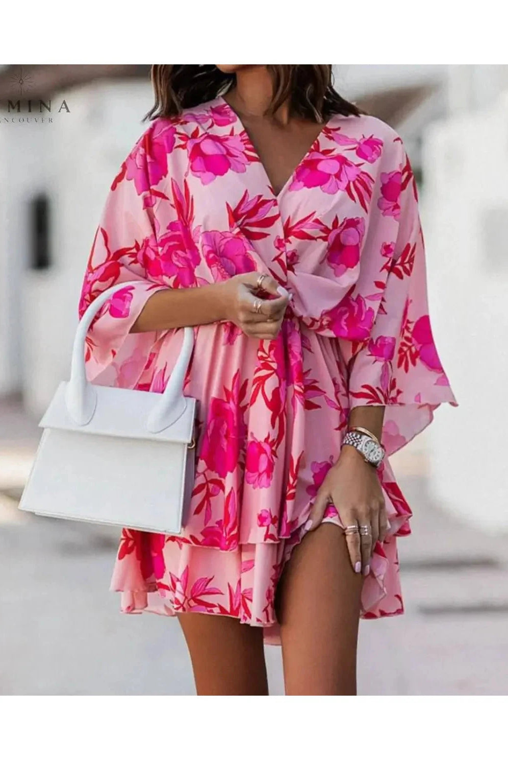 Valeria bohemian floral mini dress in orange and pink from Lumina Vancouver's summer dress collection, featuring a casual, flowy design.