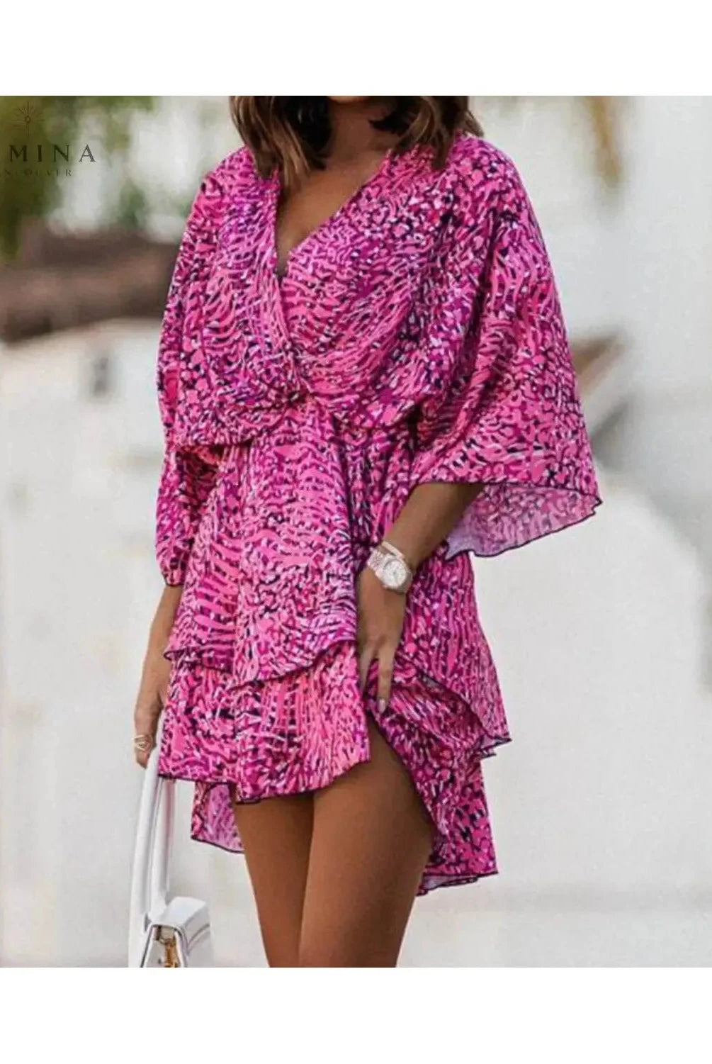 Valeria bohemian floral mini summer dress in orange and pink by Lumina Vancouver, featuring a flowy design and floral pattern.
