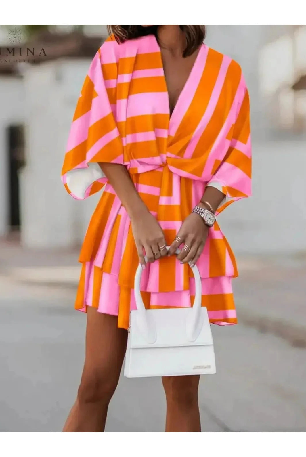 Valeria bohemian floral mini dress in orange and pink from Lumina Vancouver's summer dress collection, featuring a relaxed fit and vibrant print.