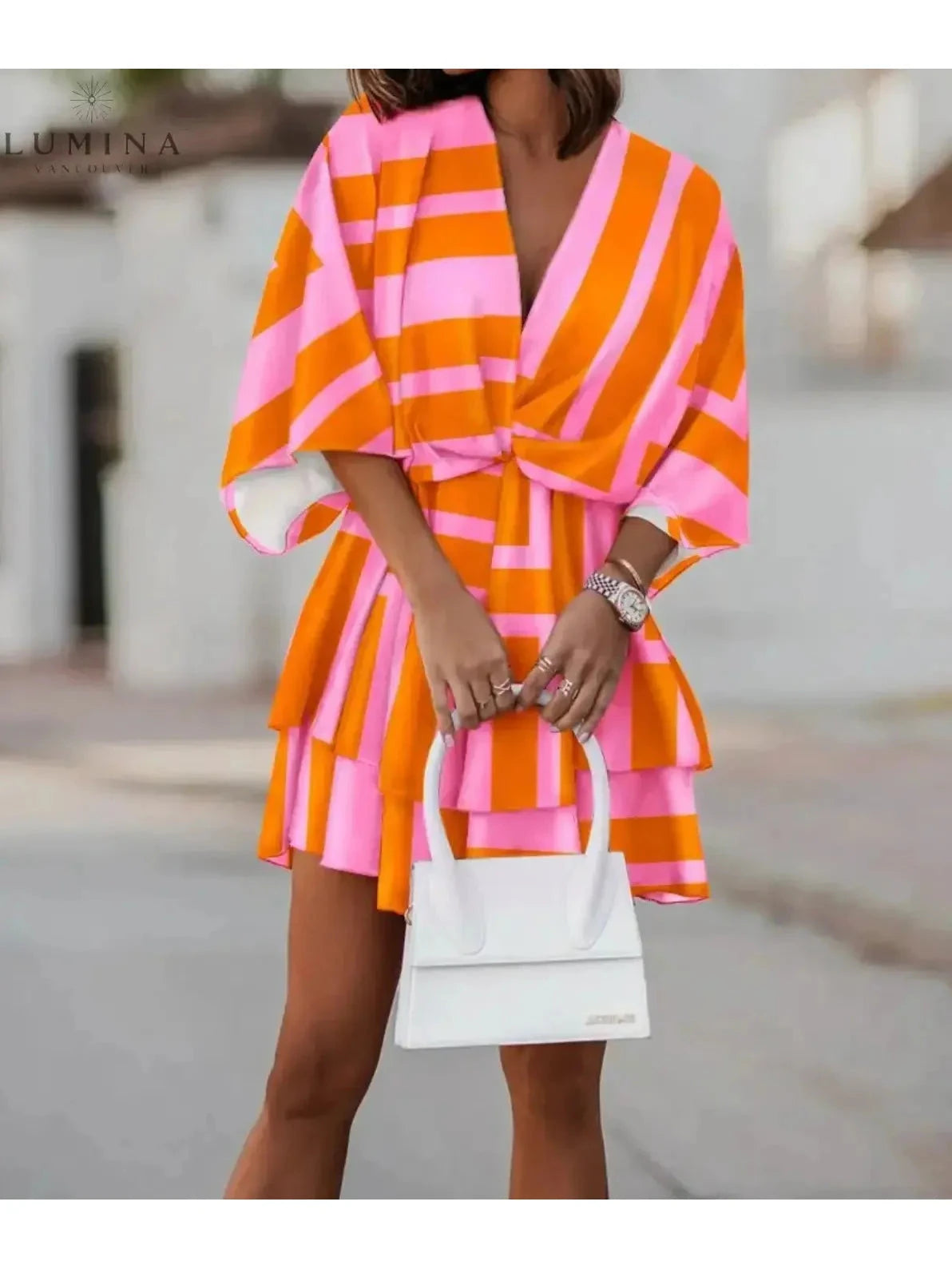 Valeria bohemian floral mini dress in orange and pink from Lumina Vancouver's summer dress collection, featuring a relaxed fit and vibrant print.