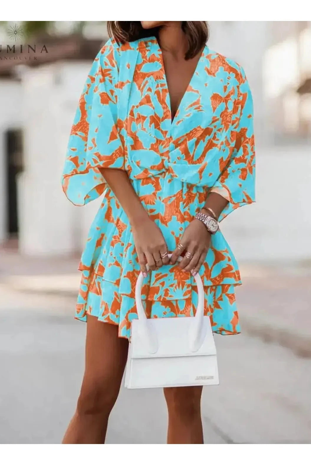 Valeria bohemian floral mini dress in orange and pink from Lumina Vancouver's summer dress collection, featuring a vibrant, flowy design.