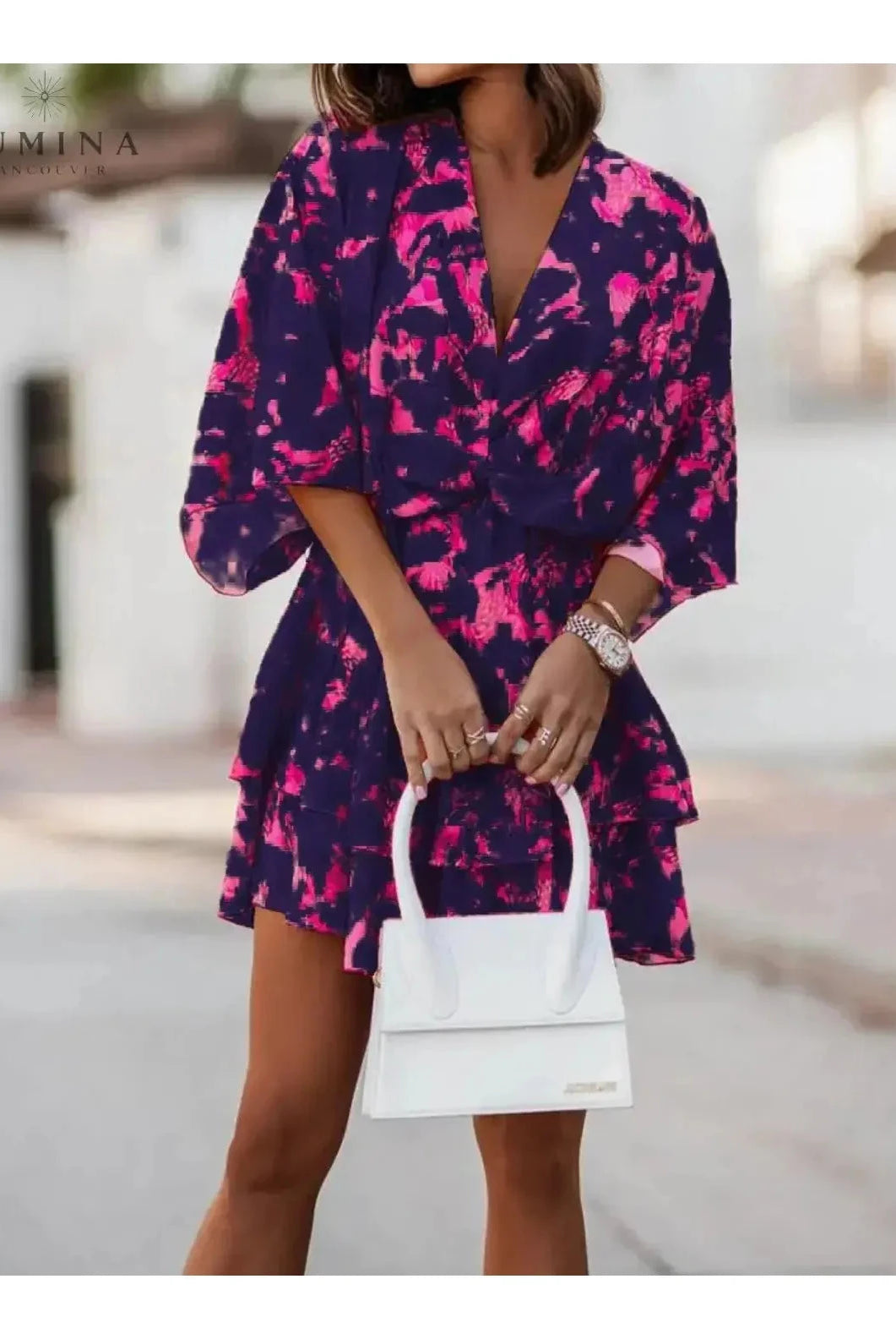 Valeria bohemian floral mini dress in orange and pink from Lumina Vancouver's summer dress collection, featuring a relaxed fit and floral pattern.