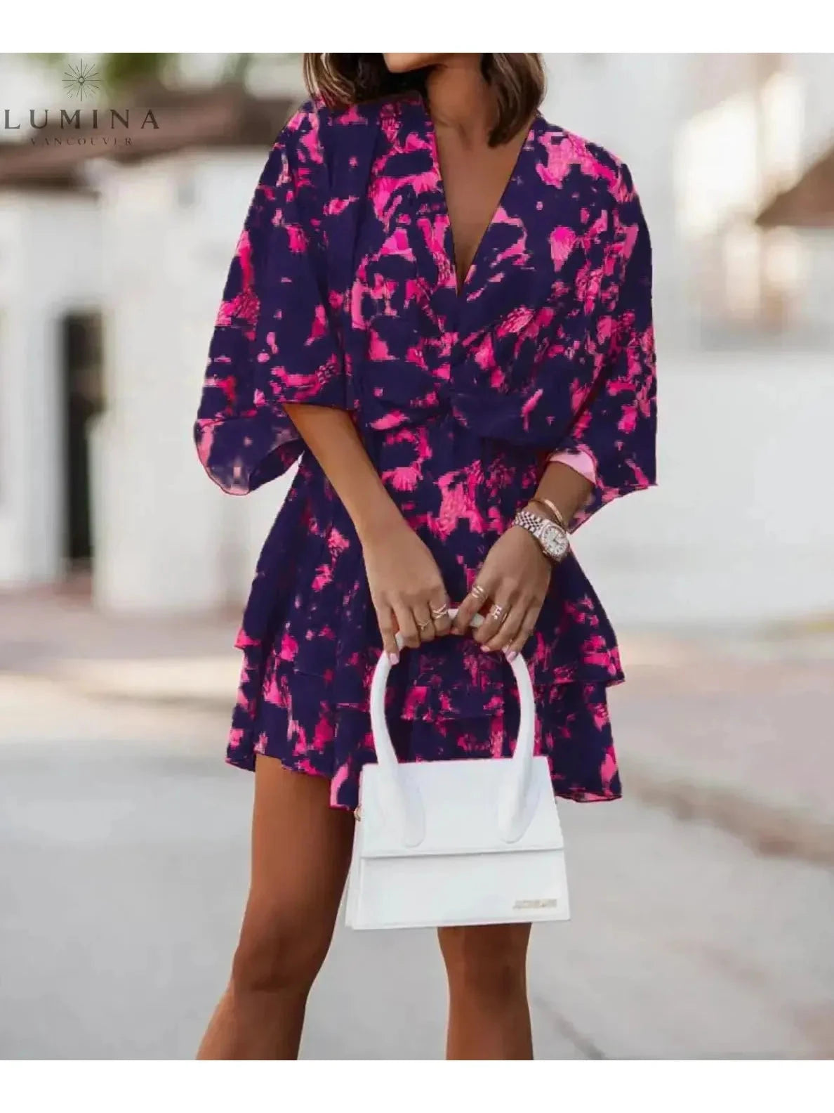 Valeria bohemian floral mini dress in orange and pink from Lumina Vancouver's summer dress collection, featuring a relaxed fit and floral pattern.