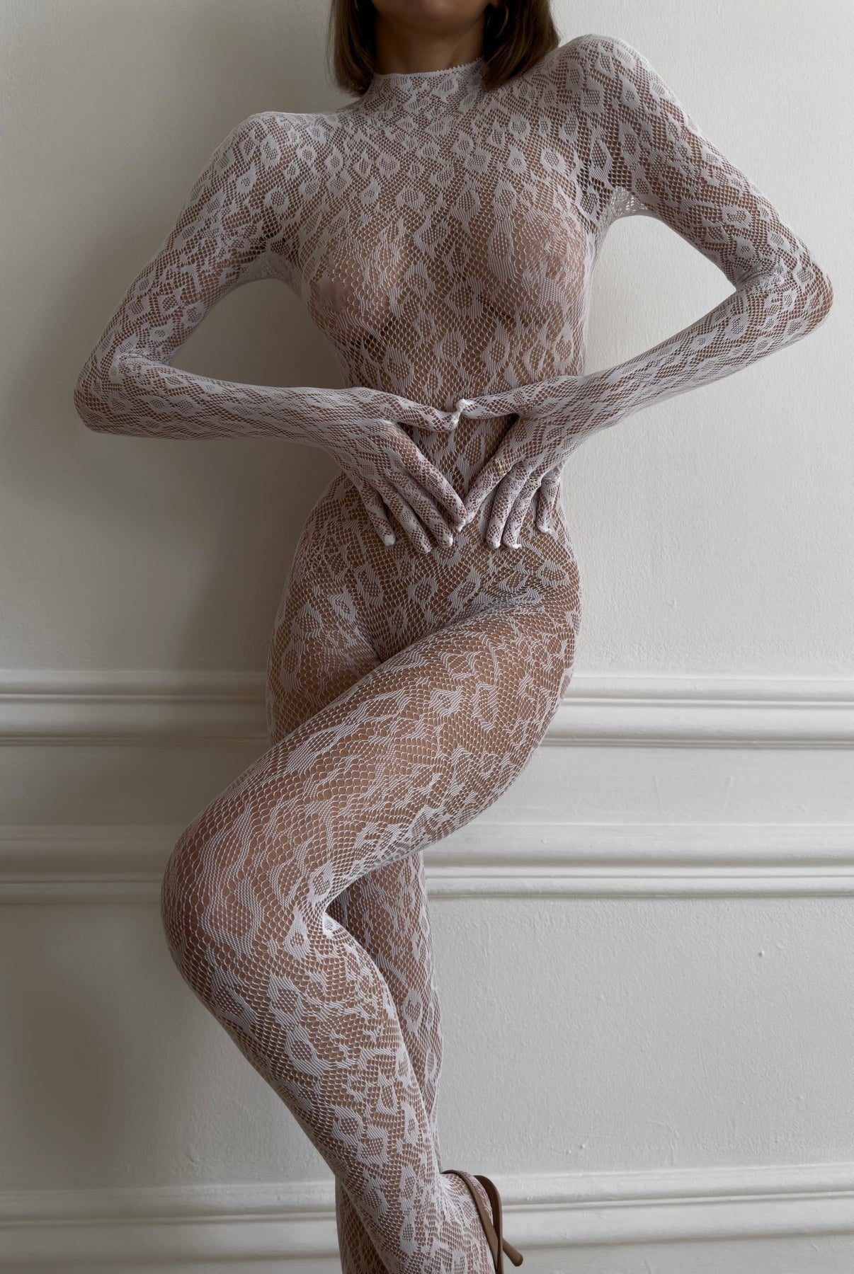 Black Idalie transparent bodysuit by Lumina Wear, featuring sheer fabric and fitted design, displayed on a mannequin.
