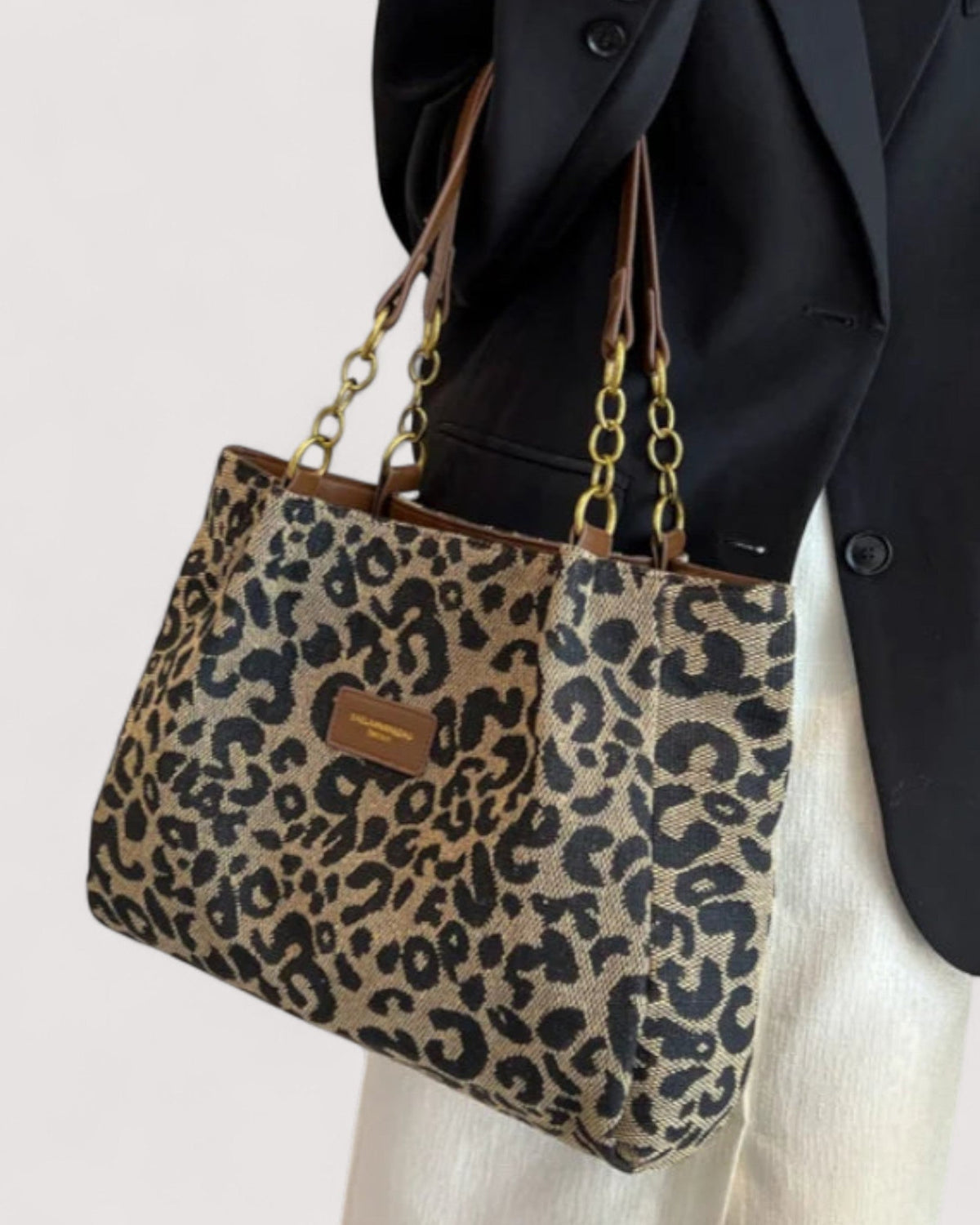 Victoria leopard print canvas handbag by Lumina Wear featuring bold animal print and sturdy handles for stylish shopping.
