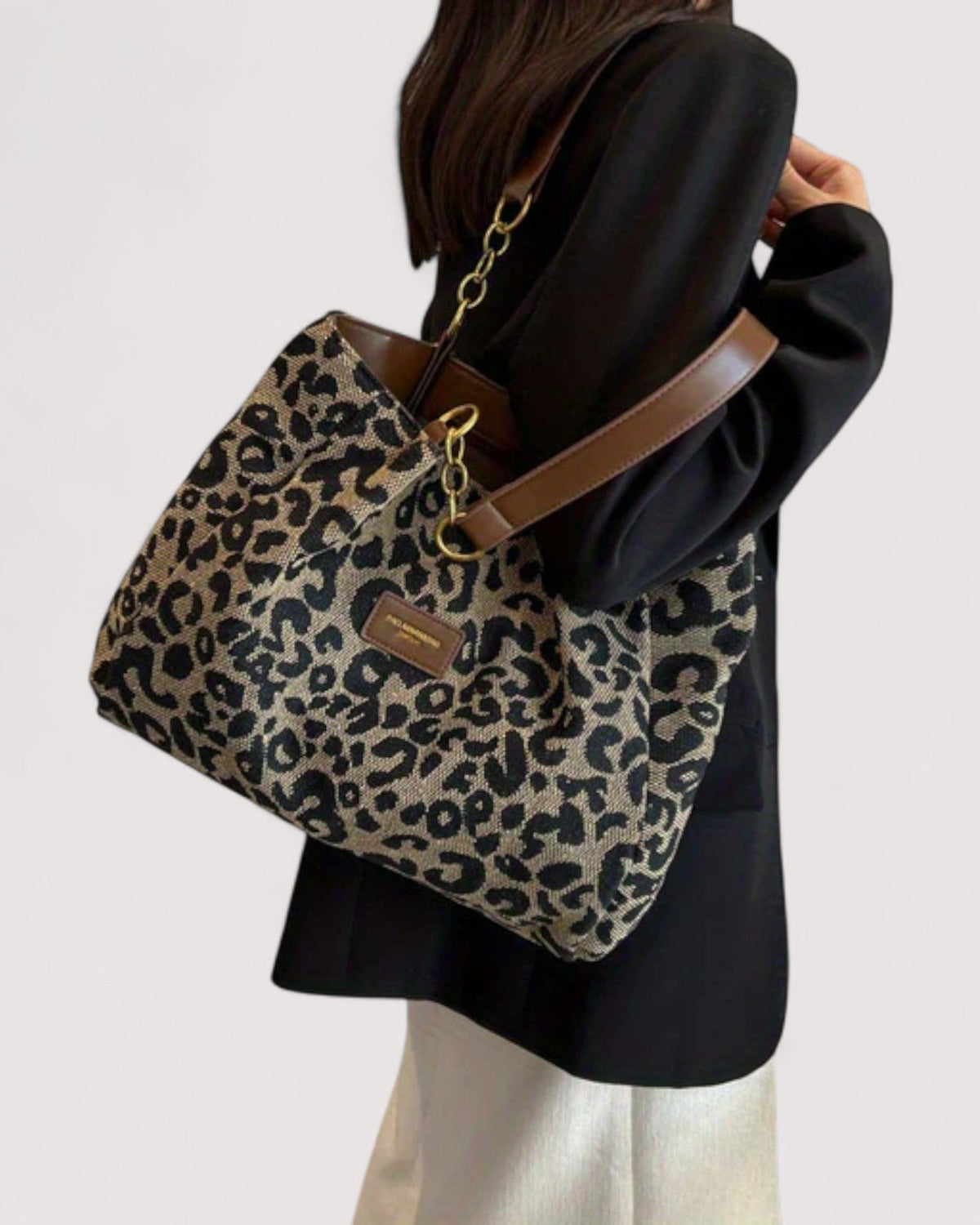 Victoria Lumina Leopard Print Canvas Shopping Bag featuring bold leopard pattern, durable handles, and spacious interior.
