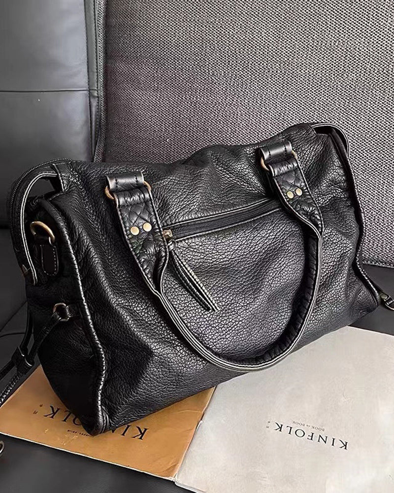Victoria Lumina black PU leather handbag with multiple pockets, featuring a sleek design and sturdy handles.